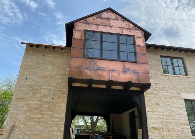 Copper metal panel facade on a stone building for Skylight Installation in Sanger